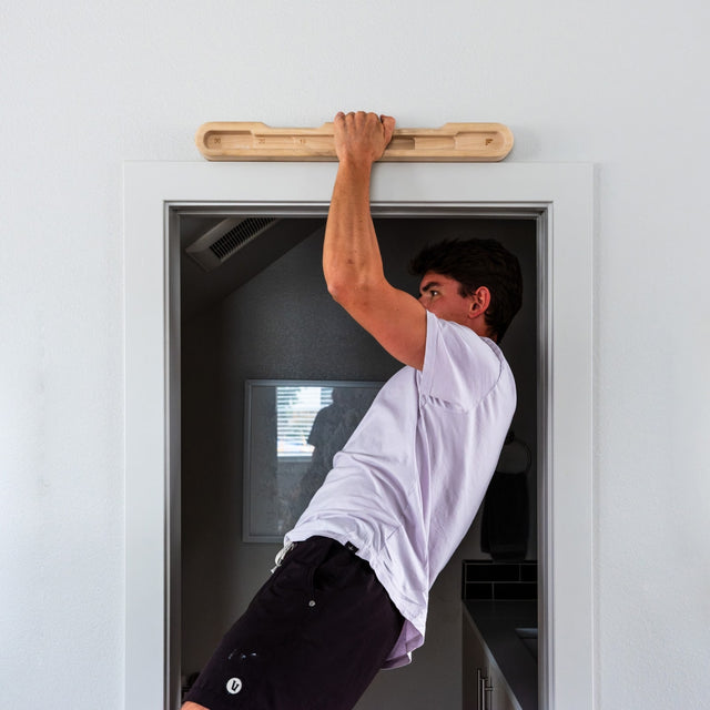 Person doing one arm pull-up on DoorMount Pro