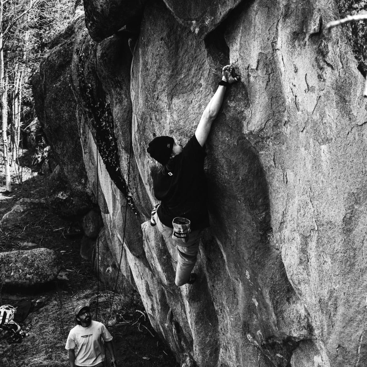 Joel climbing while wearing the logo tee