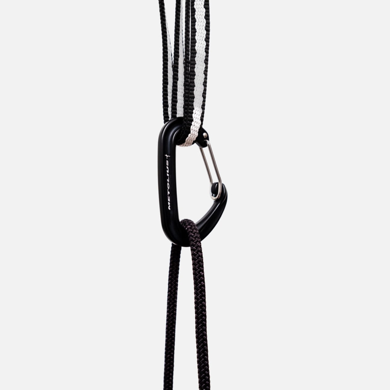 Carabiner clipped to the sling, with cord running down to a training tool
