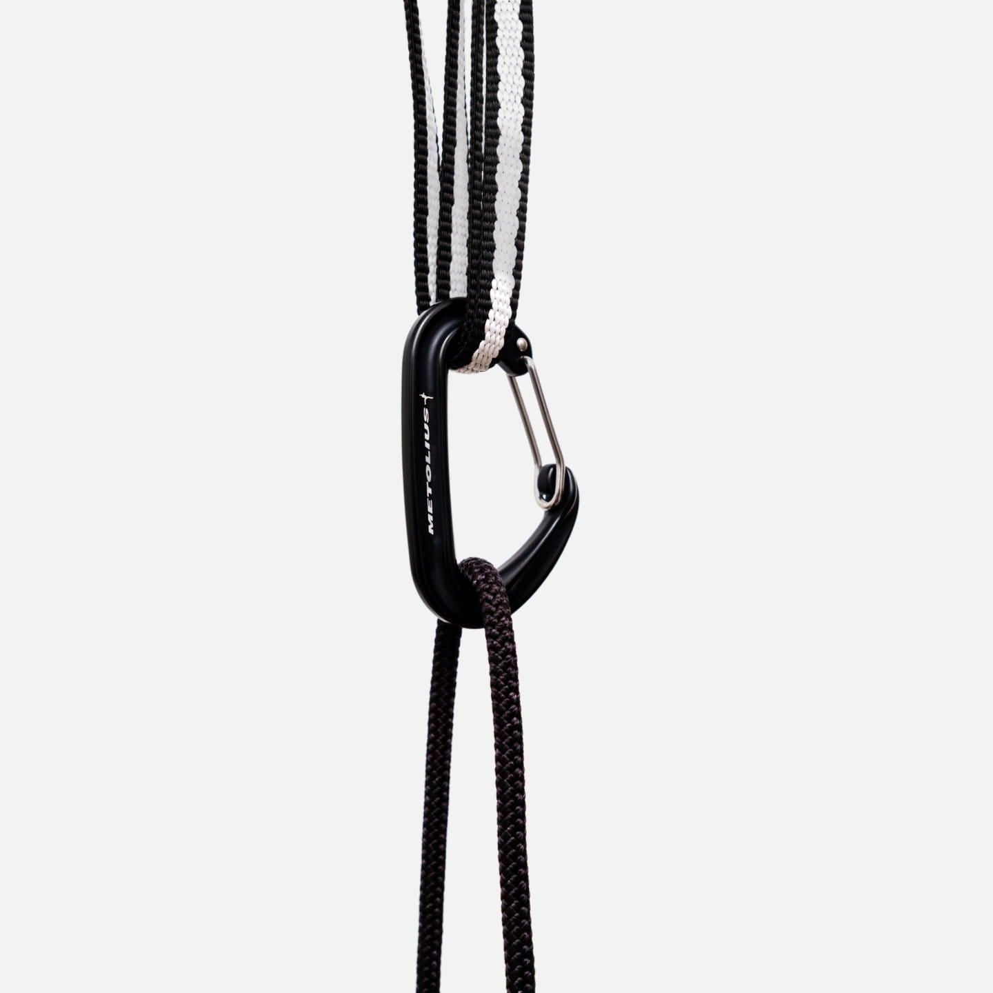 Carabiner clipped to the sling, with cord running down to a training tool